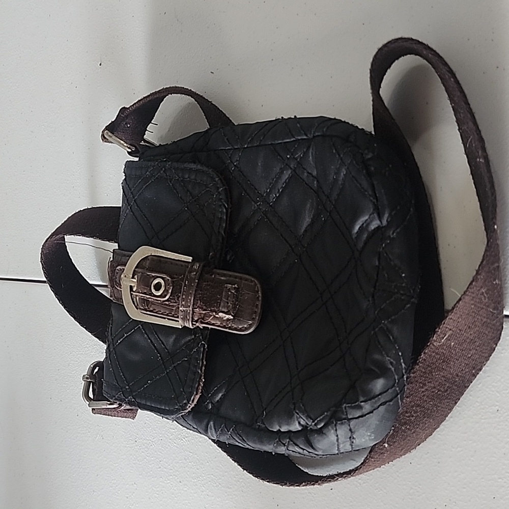 Avon classic quilted crossbody black with brown lining. Buckle front used…